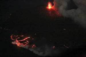 写真３：ストロンボリ式噴火を繰り返す中央火砕丘と海に注ぐ溶岩流が夜間にはよくわかる。途中から溶岩が地上に現れそのまま海に注ぐ溶岩チューブシステムの様子がよく分かる。北東側から撮影。